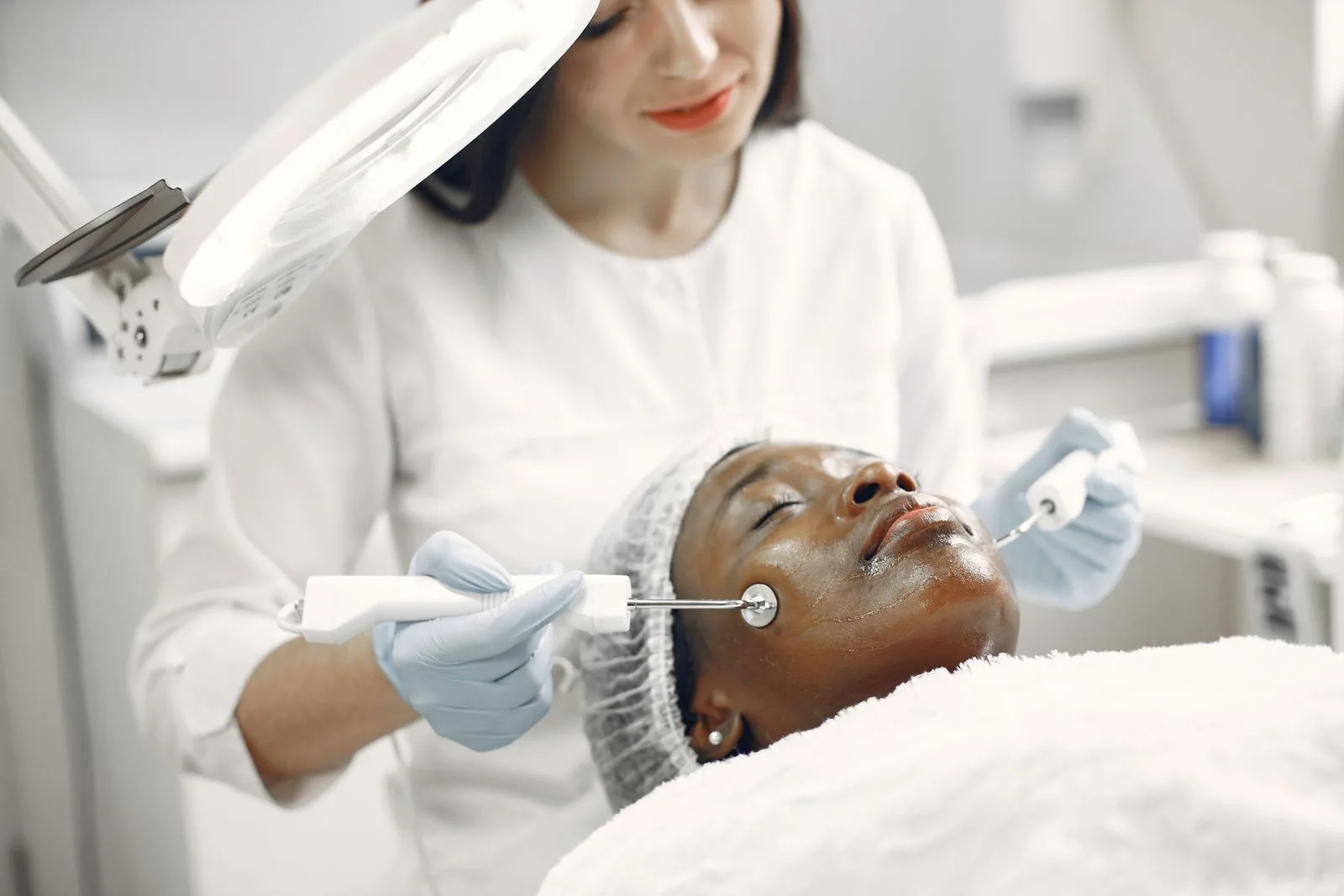 A practitioner performing a facial treatment, combining botox and fillers in a modern Malta clinic