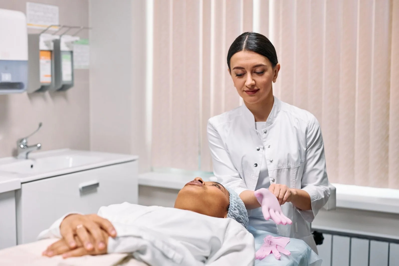 A cosmetologist in gloves preparing a treatment, representing a qualified injector at a Malta aesthetic clinic