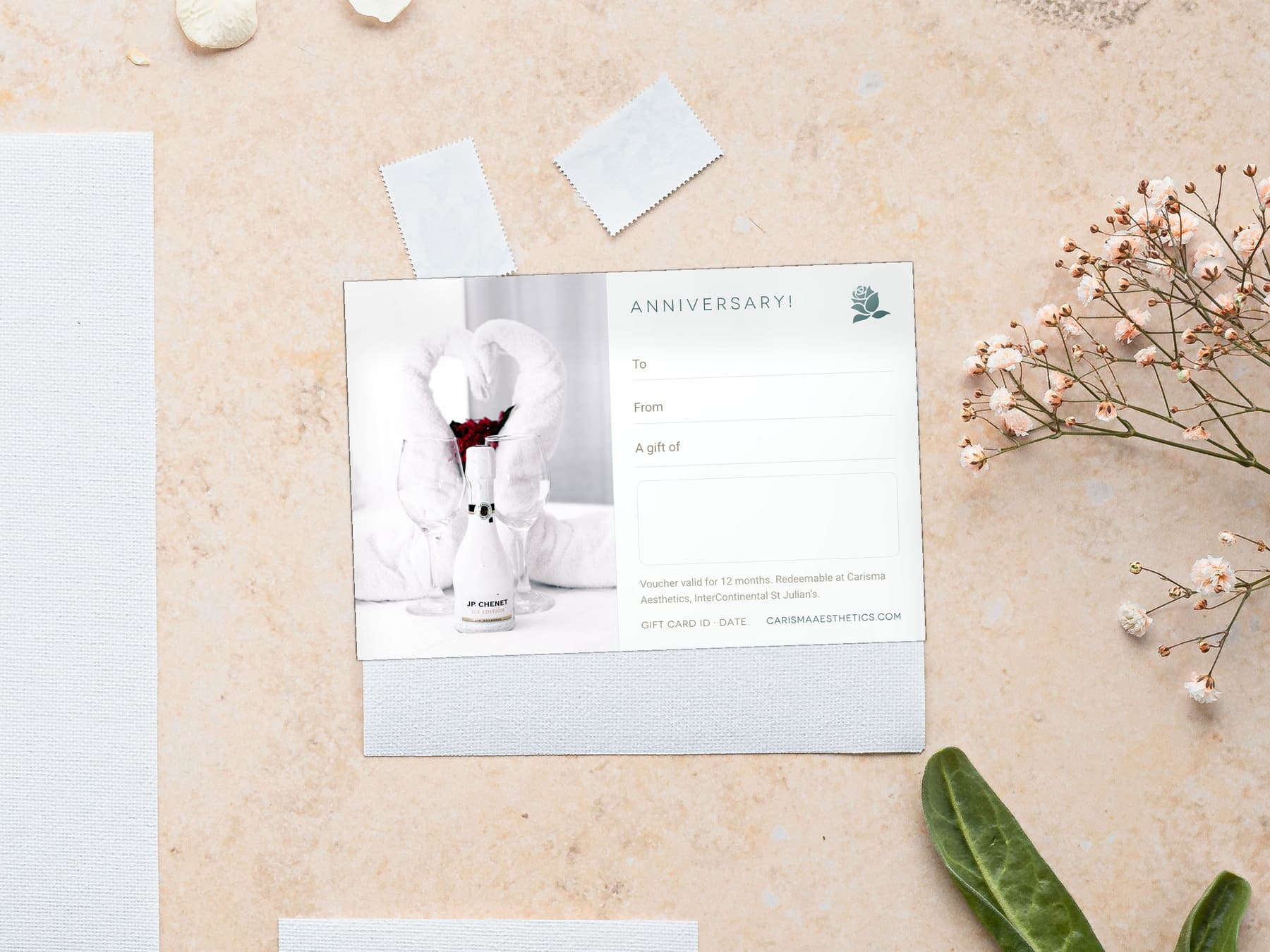 A Carisma Aesthetics anniversary gift card laid on cool marble — Anniversary gift cards at Carisma Aesthetics Malta