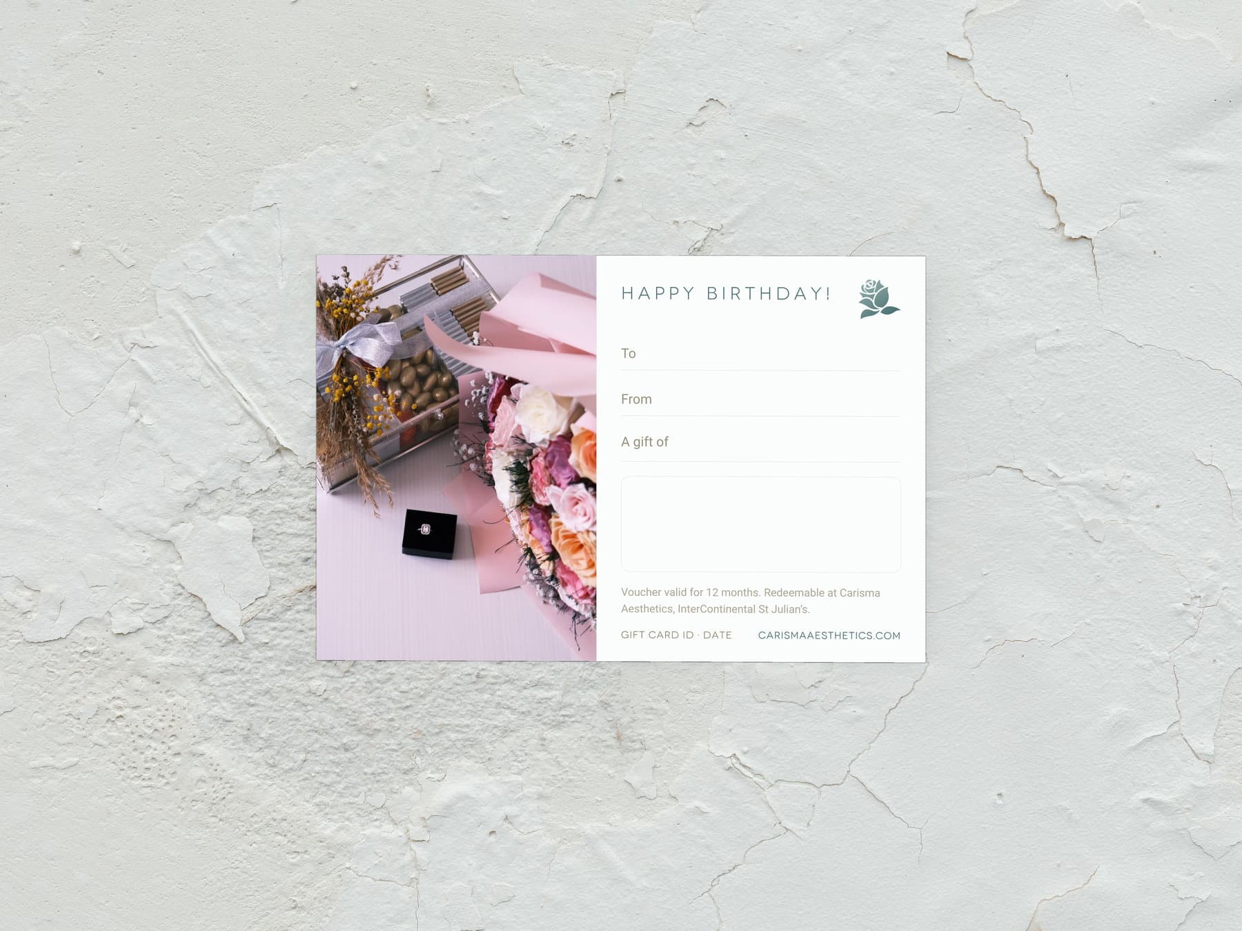 A Carisma Aesthetics birthday gift card laid on white plaster — Birthday gift cards at Carisma Aesthetics Malta
