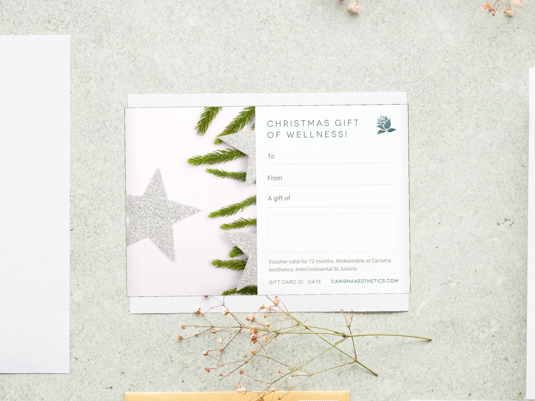 A Carisma Aesthetics Christmas gift card with silver stars and spruce on bone linen — Christmas gift cards at Carisma Aesthetics Malta