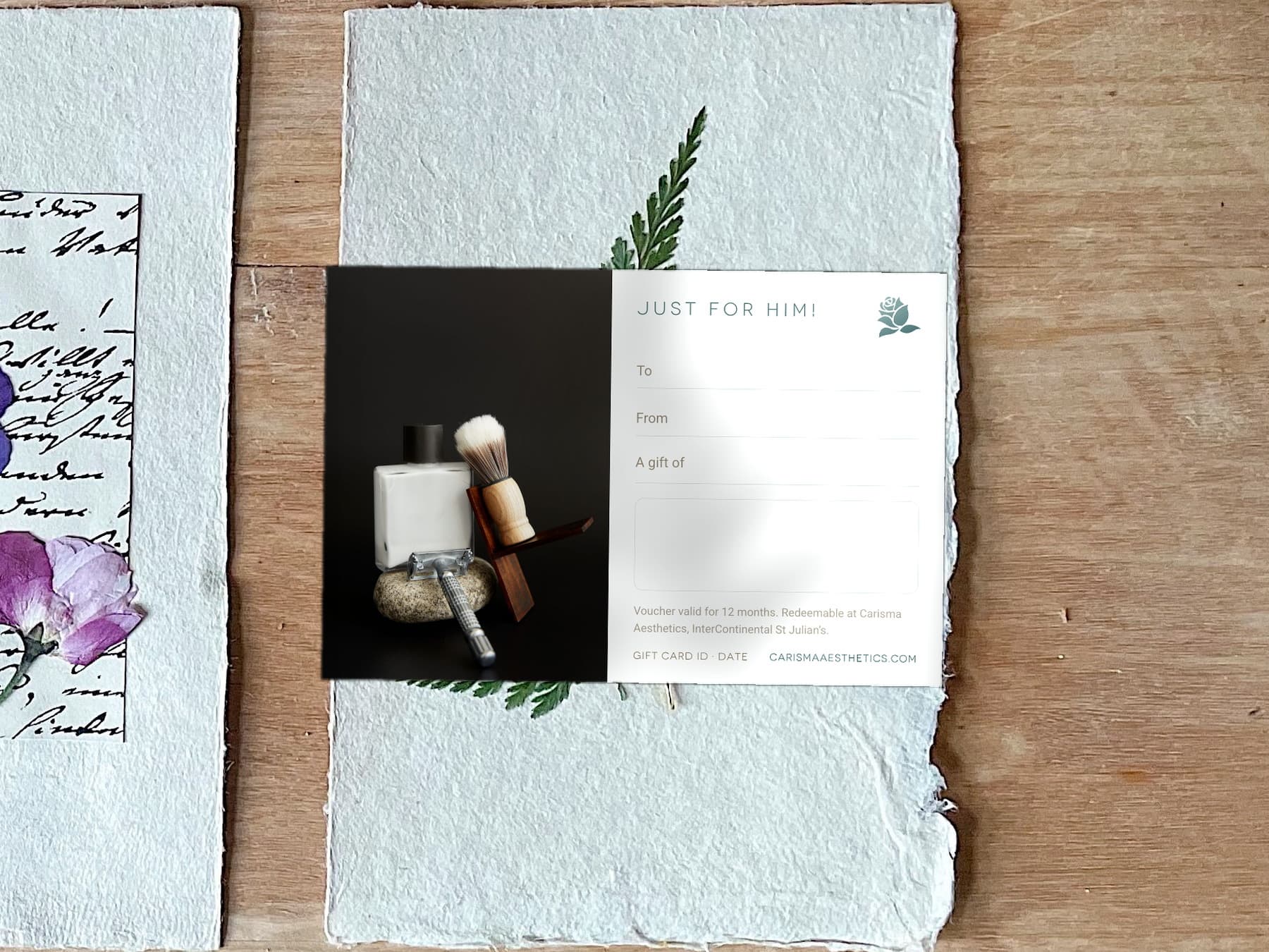 A Carisma Aesthetics Father's Day gift card on a cork coaster against cool pale stone — Father's Day gift cards at Carisma Aesthetics Malta